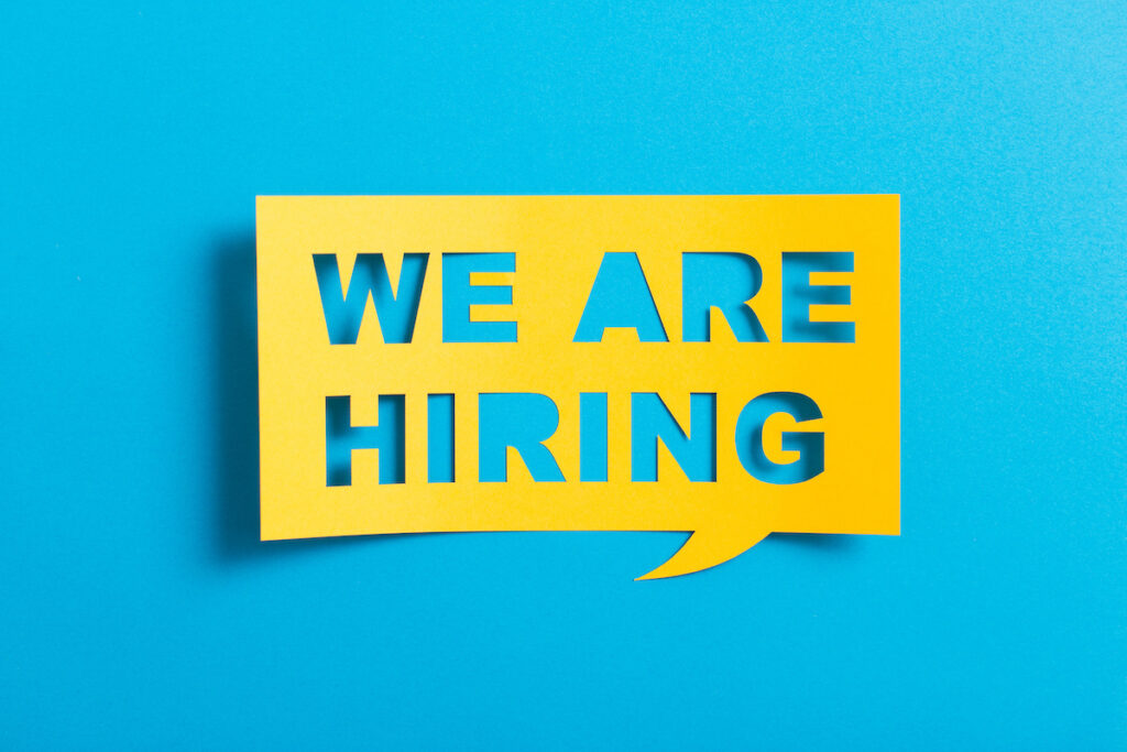 Bubble-speech-with-cut-out-phrase-"we-are-hiring"-in-the-paper.